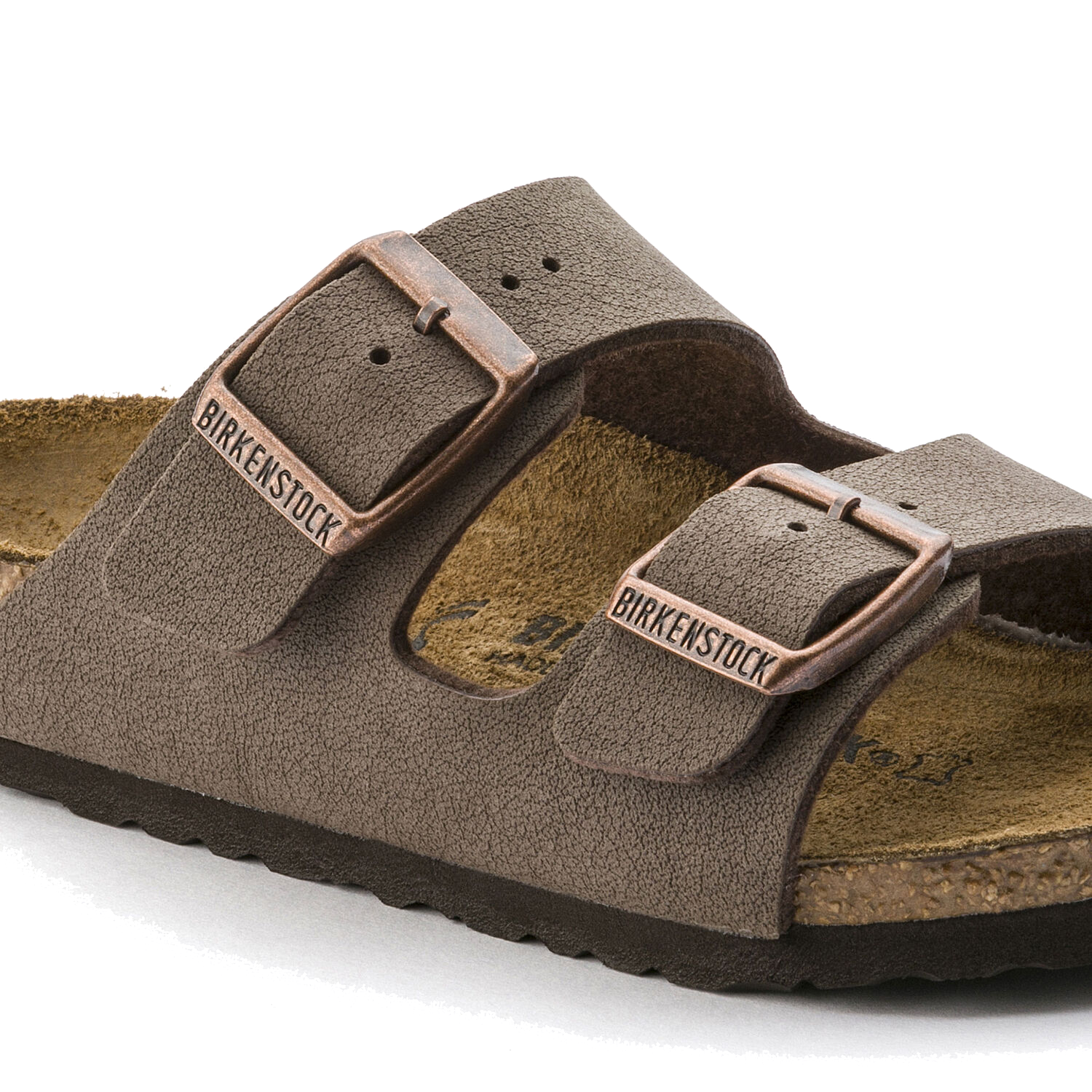 Brown suede two-strap sandals with adjustable buckles on white background