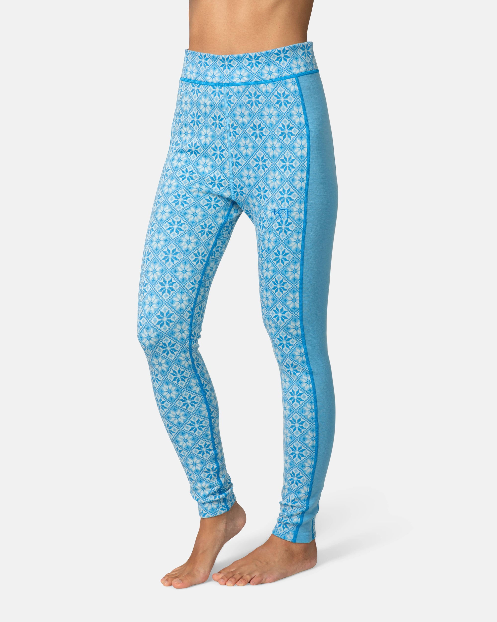 High-waist base layer leggings with blue Nordic snowflake pattern and solid side panels, front view