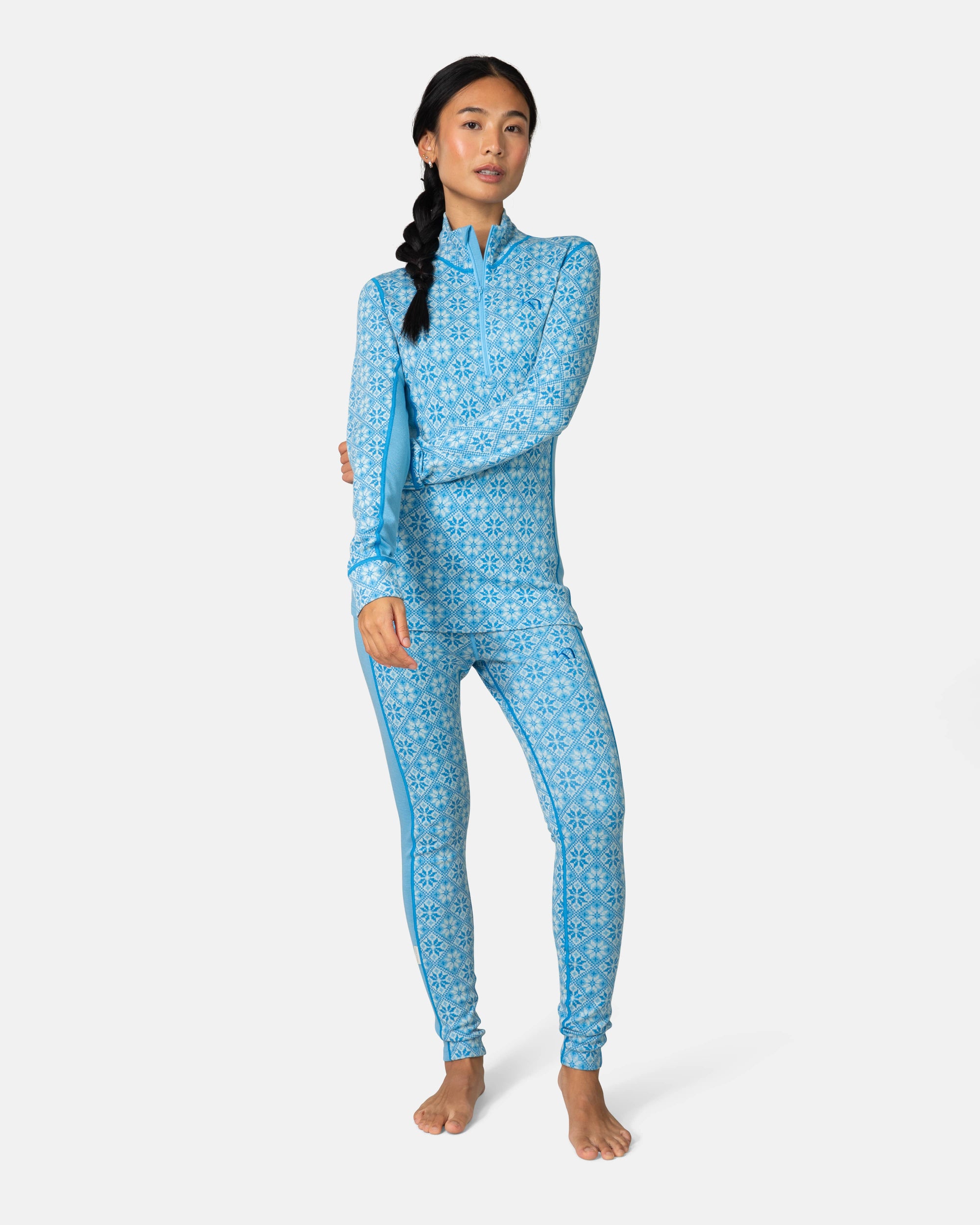 Women's blue Nordic-patterned half-zip base layer top and matching leggings, front view