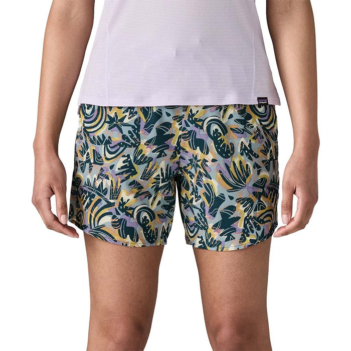 Women's athletic shorts with colorful tropical leaf print pattern, front view