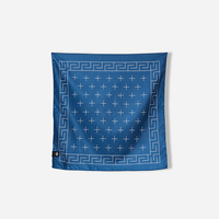 Dark blue bandana towel with geometric border and cross pattern, flat lay view