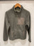 Olive green sherpa fleece jacket with full zip and chest pocket on wooden hanger