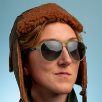 Olive green aviator sunglasses with mirrored lenses worn by person in winter hat