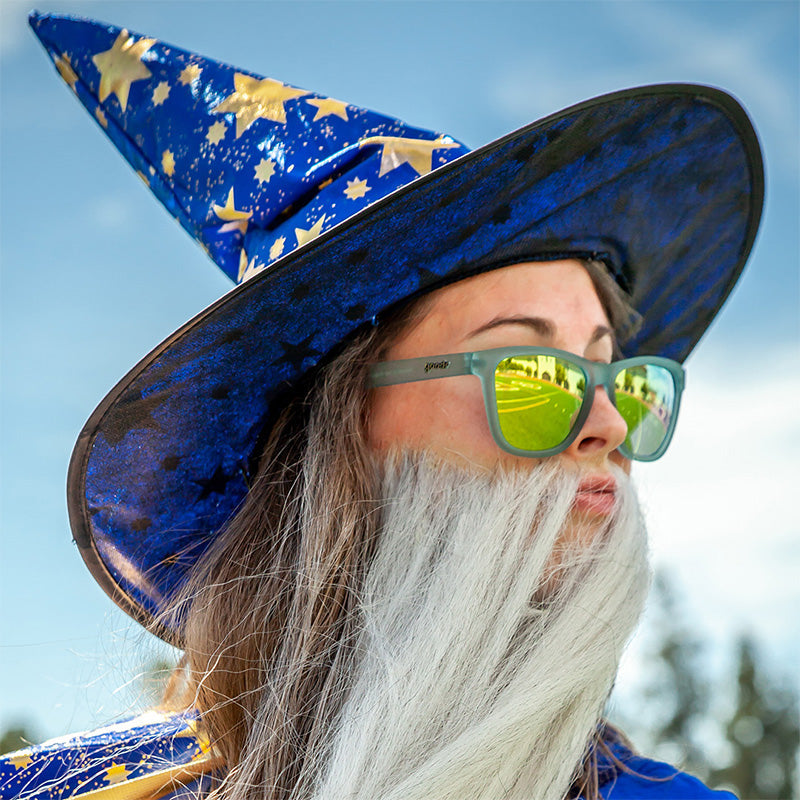 Reflective yellow-green sunglasses worn by person in wizard costume outdoors