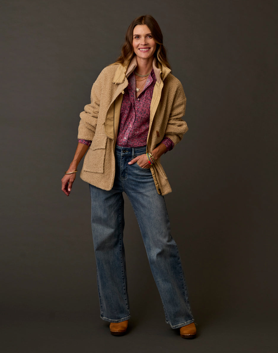Women's boucle fleece coat in warm tan, open front with patch pockets, worn over floral shirt
