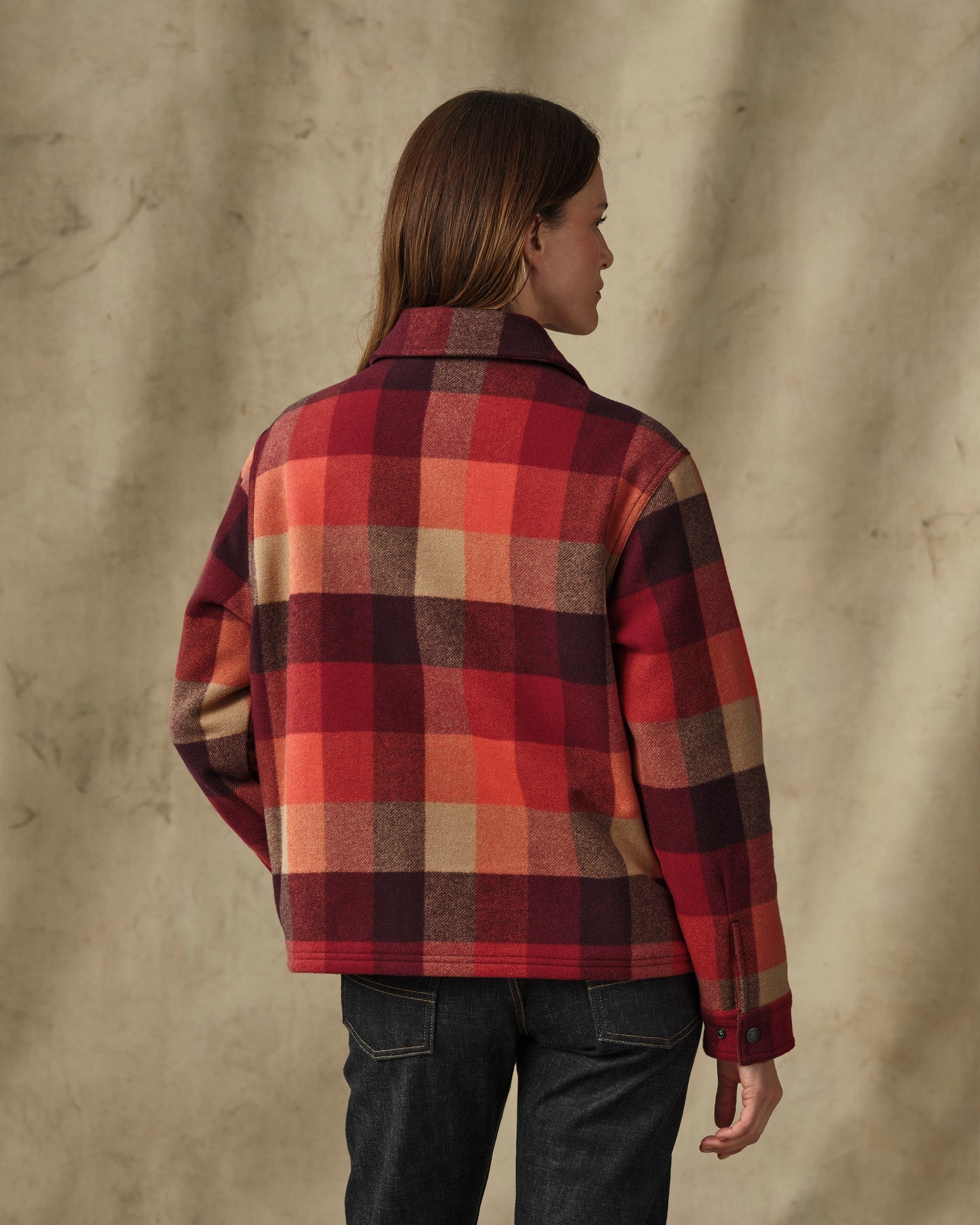 Women's plaid wool jacket in red and burgundy check, back view on model with dark jeans