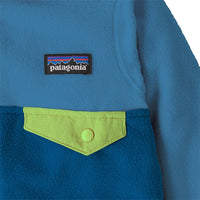 Close-up detail of fleece jacket chest pocket with lime green flap and snap button closure