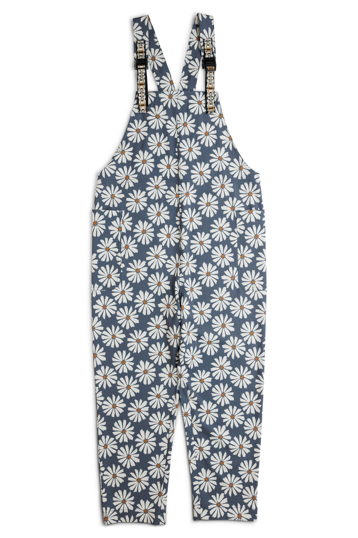 Blue overalls with white daisy floral pattern and adjustable straps, front view
