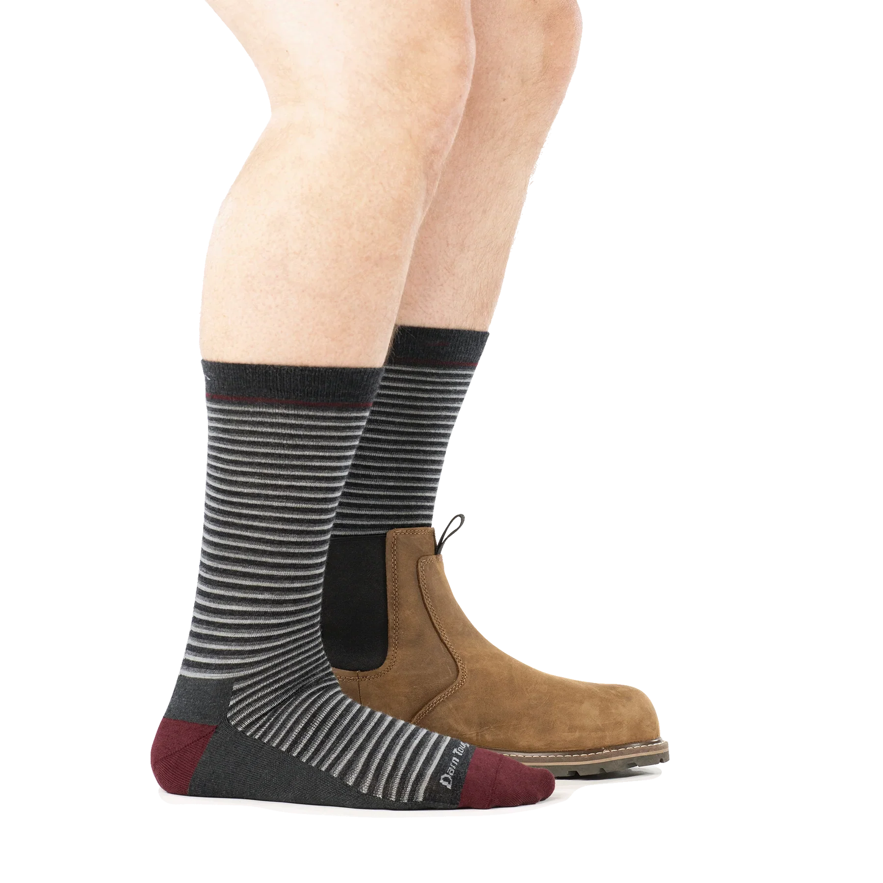 Side view of striped crew socks in charcoal with burgundy toe, worn with brown Chelsea boot