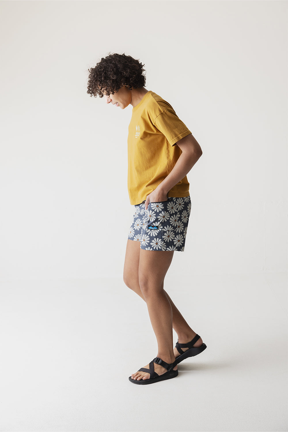 Women's shorts with gray background and white daisy floral pattern, side view