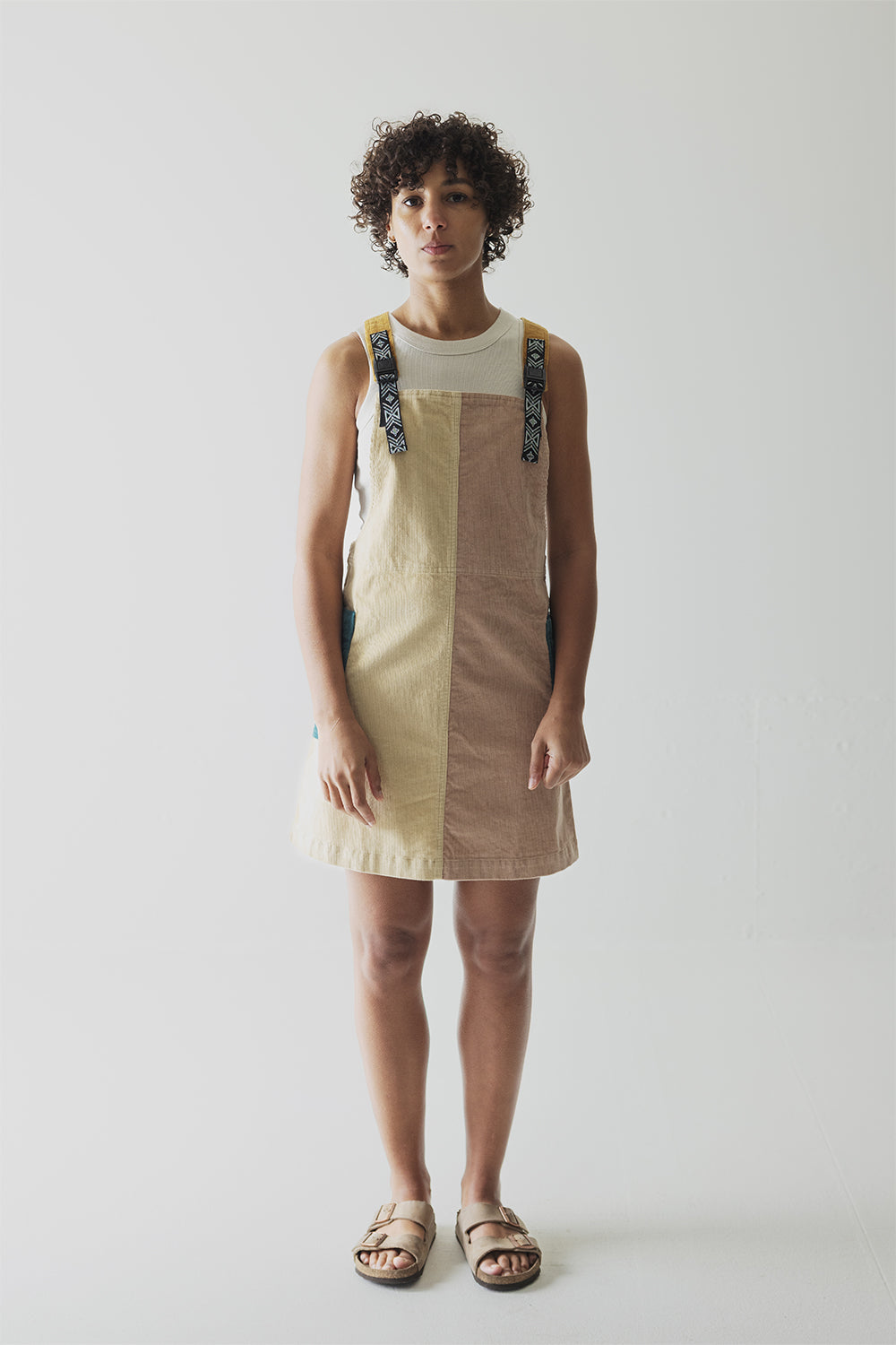 Colorblock jumper dress with decorative shoulder straps in tan and brown tones