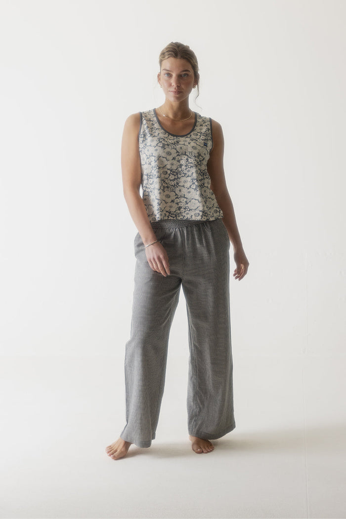 Gray corduroy wide-leg pants with elastic waistband worn by woman on white background