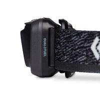Close-up side view of headlamp battery pack with Dual Fuel label and patterned elastic strap