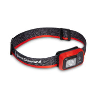 Headlamp with red-orange housing and adjustable gray elastic strap, angled front view