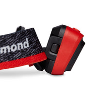 Close-up detail of a headlamp showing tilt mechanism, power button, and elastic headband