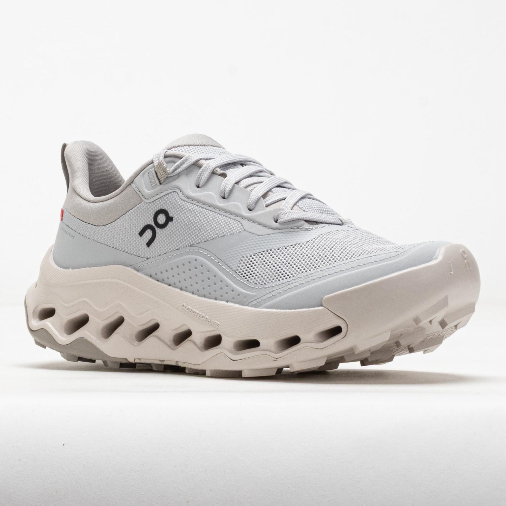 Light gray running shoe with distinctive chunky sole featuring ventilation holes, side profile view