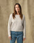 Women's waffle knit crewneck sweater in light cream, front view on model with jeans