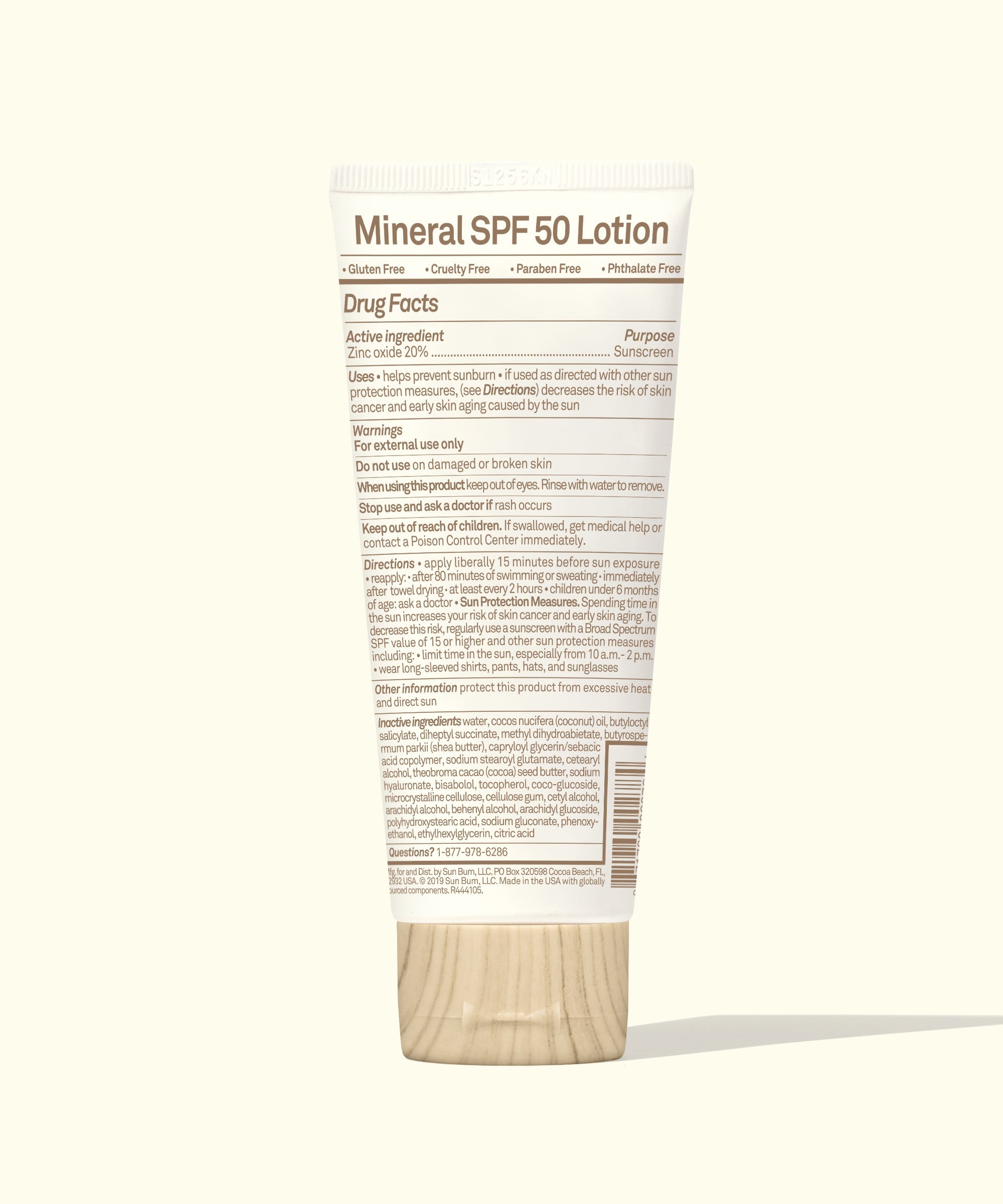 White sunscreen lotion tube with wooden cap showing back label with SPF 50 details