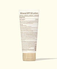 White sunscreen lotion tube with wooden cap showing back label with SPF 50 details