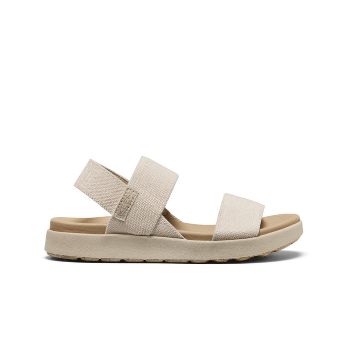 Light beige canvas sandal with adjustable straps and cushioned sole, side profile view