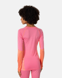 Women's long sleeve base layer top in pink with coral color-block panels, back view on model