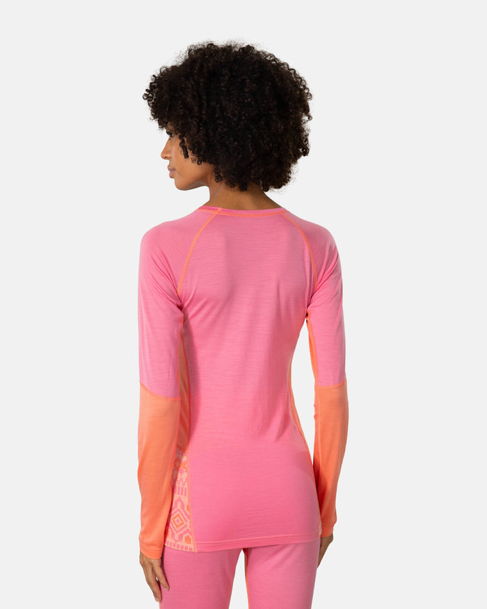 Women's long sleeve base layer top in pink with coral color-block panels, back view on model