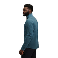 Man wearing teal half-zip fleece jacket shown from side profile view