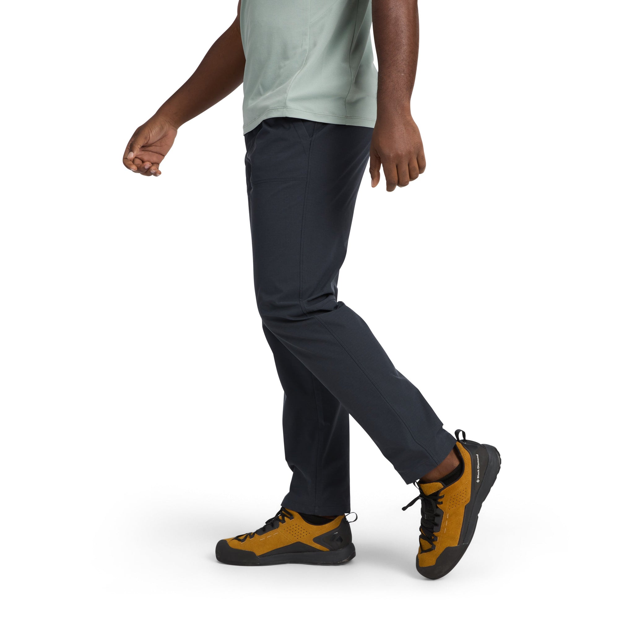 Dark colored athletic pants worn by person in walking pose, side view