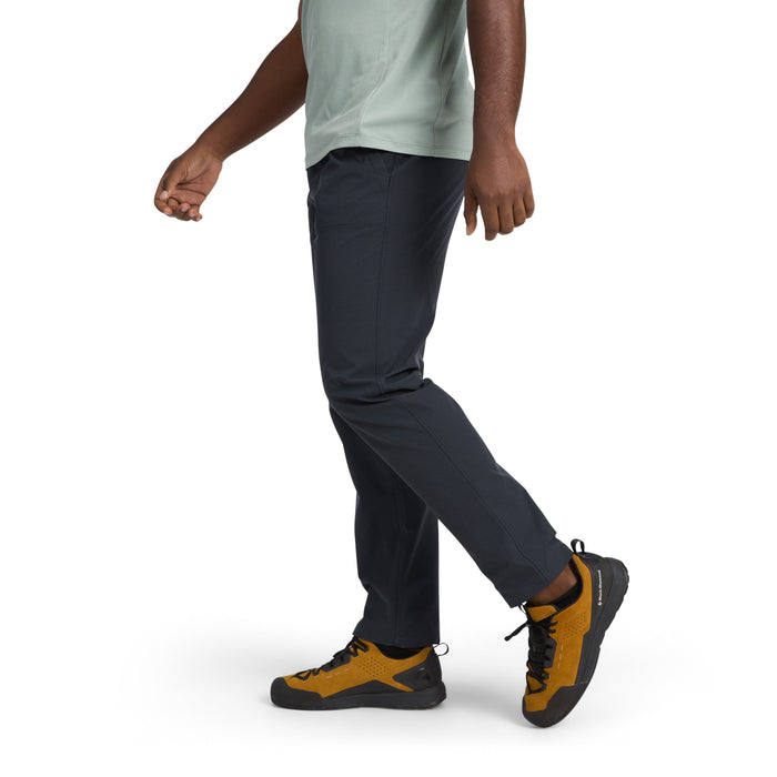 Dark colored athletic pants worn by person in walking pose, side view