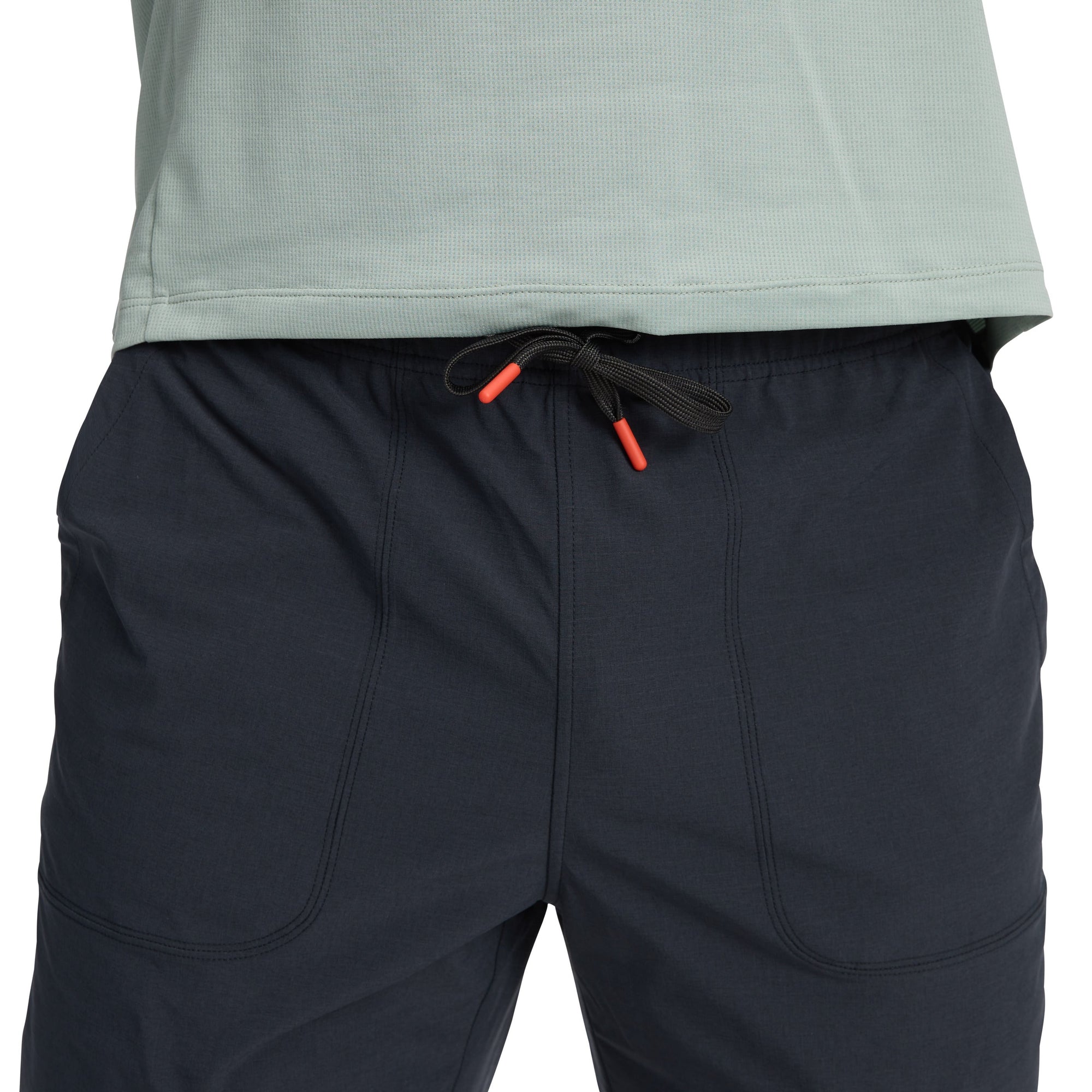 Dark blue athletic pants with drawstring waist and curved seam details, front view