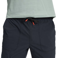 Dark blue athletic pants with drawstring waist and curved seam details, front view