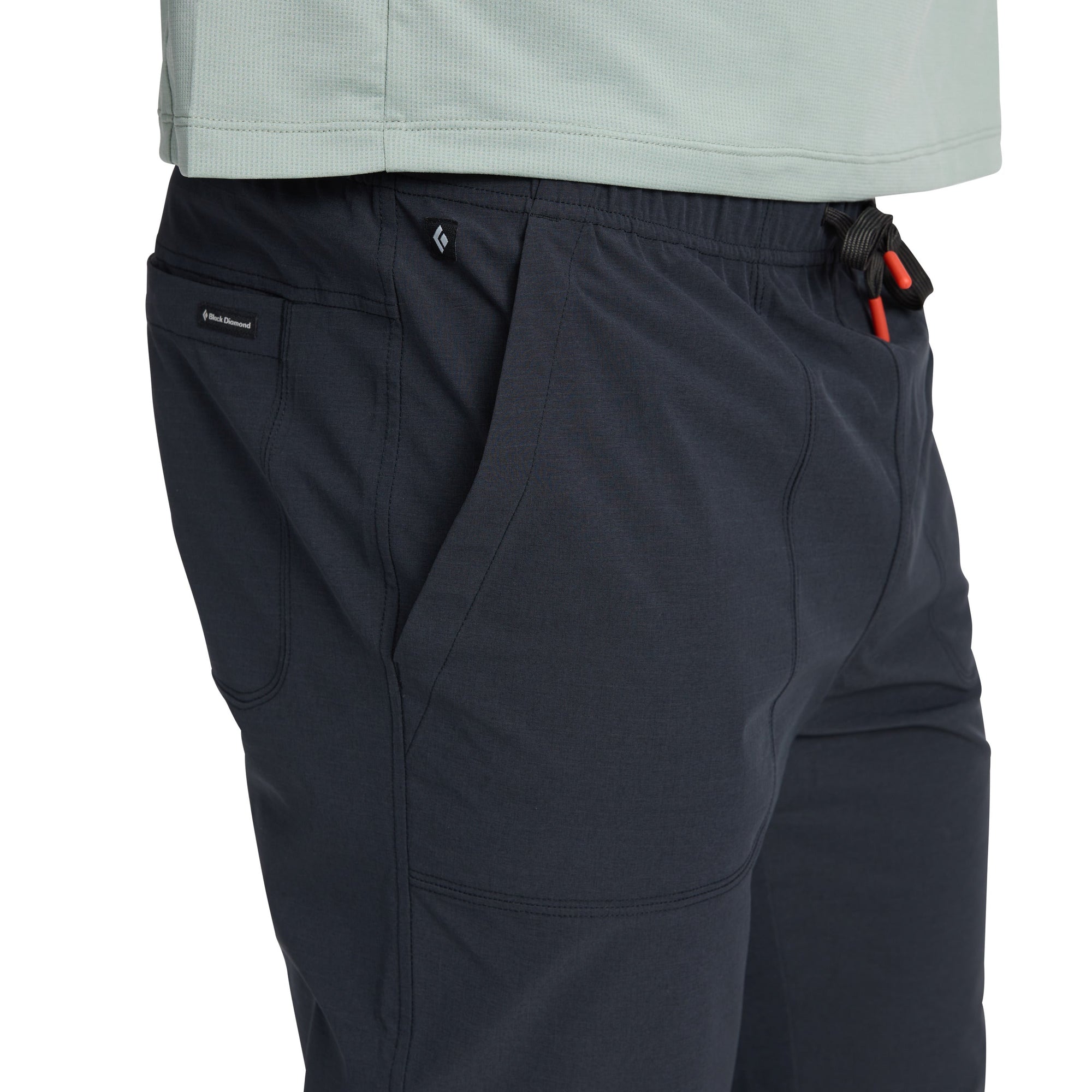 Dark navy outdoor pants with front pockets and belt detail, side angle view