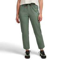Olive green athletic pants with elastic waist and drawstring, worn with hiking boots