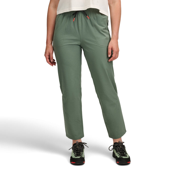 Olive green athletic pants with elastic waist and drawstring, worn with hiking boots