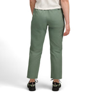 Women's casual pants in sage green color shown from back view with outdoor sneakers