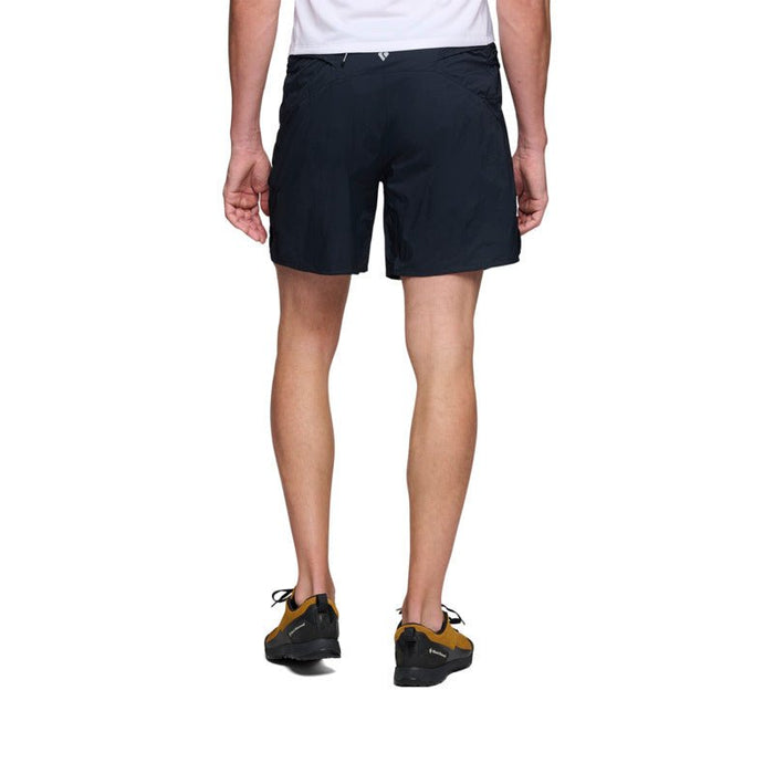 Black athletic shorts shown from back view, mid-thigh length with fitted waistband