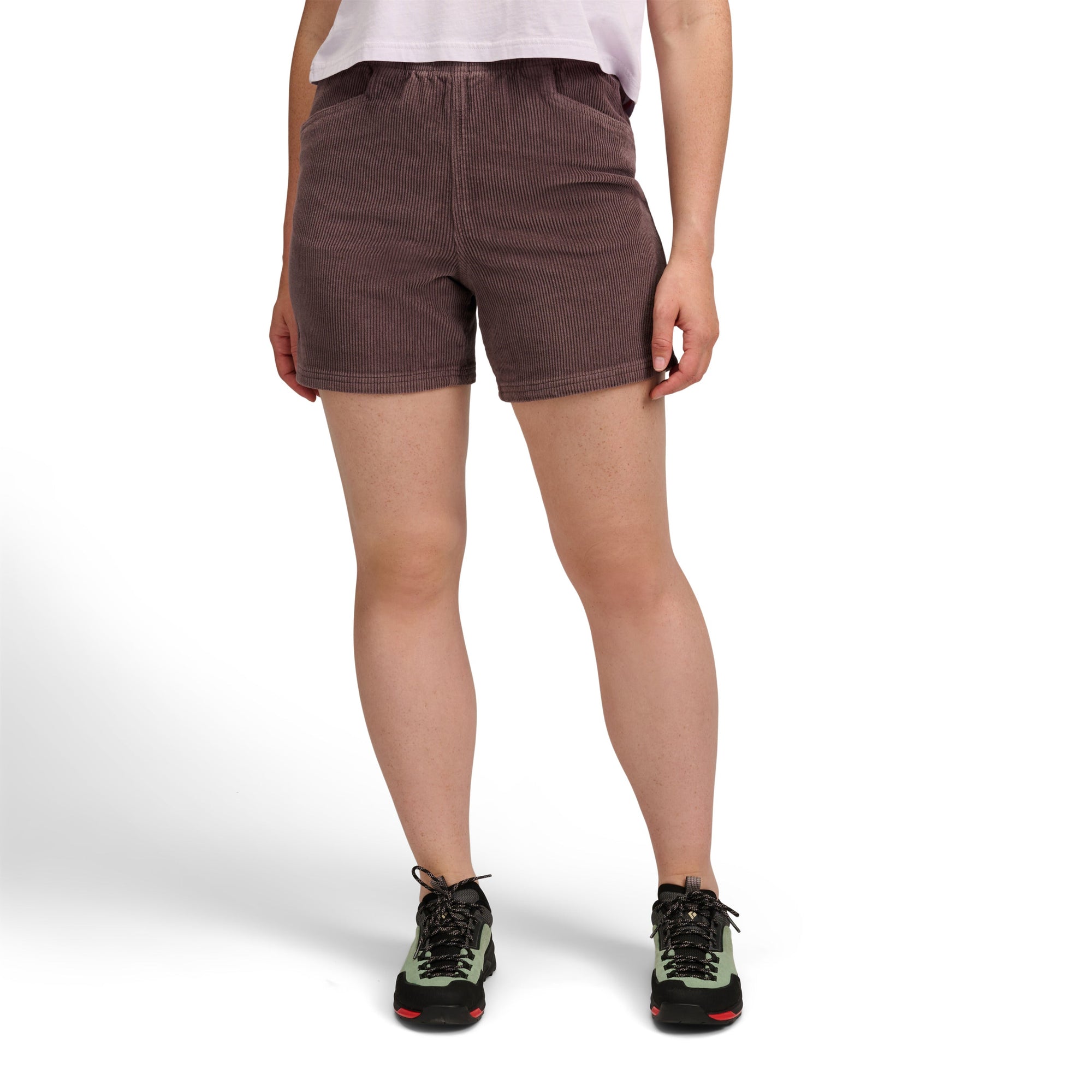 Women's corduroy shorts in dark mauve worn with hiking shoes, front view