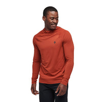 Rust orange hooded athletic top with long sleeves on male model, studio lighting