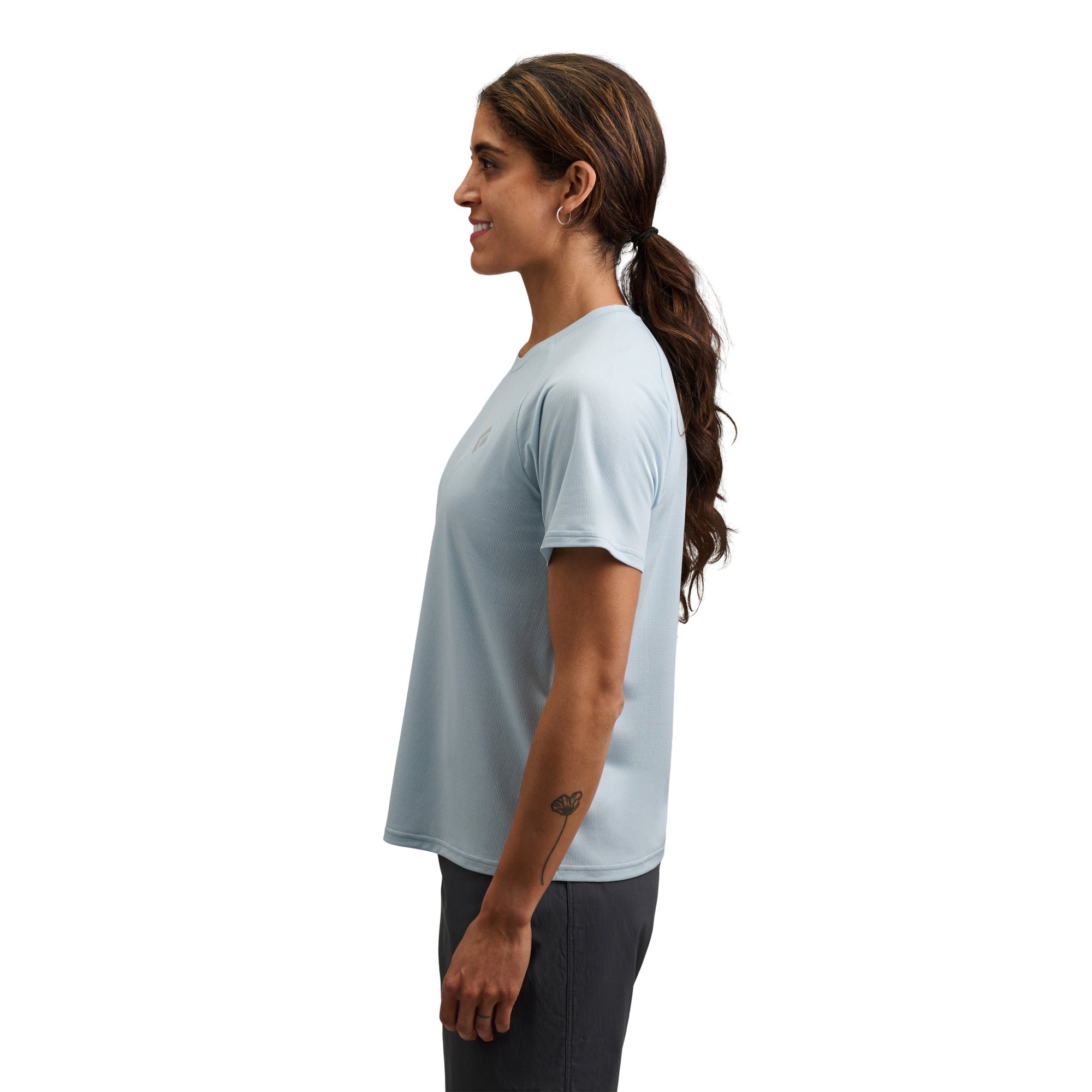 Light blue short sleeve tee shirt shown from side profile on woman with ponytail