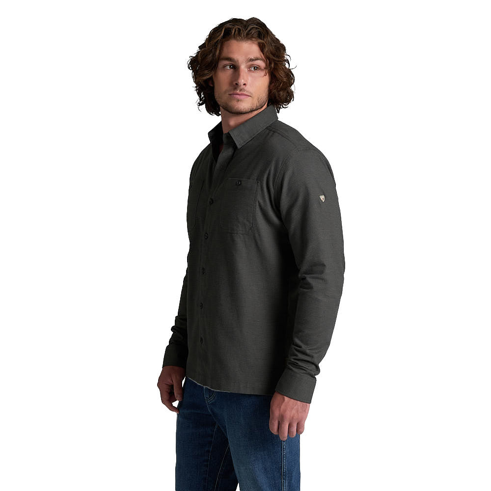 Men's long-sleeve flannel button-up shirt in dark charcoal, three-quarter view on model with jeans