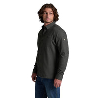 Men's long-sleeve flannel button-up shirt in dark charcoal, three-quarter view on model with jeans