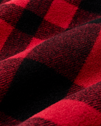 Close-up detail of heavyweight wool fabric in bold red and black plaid check pattern