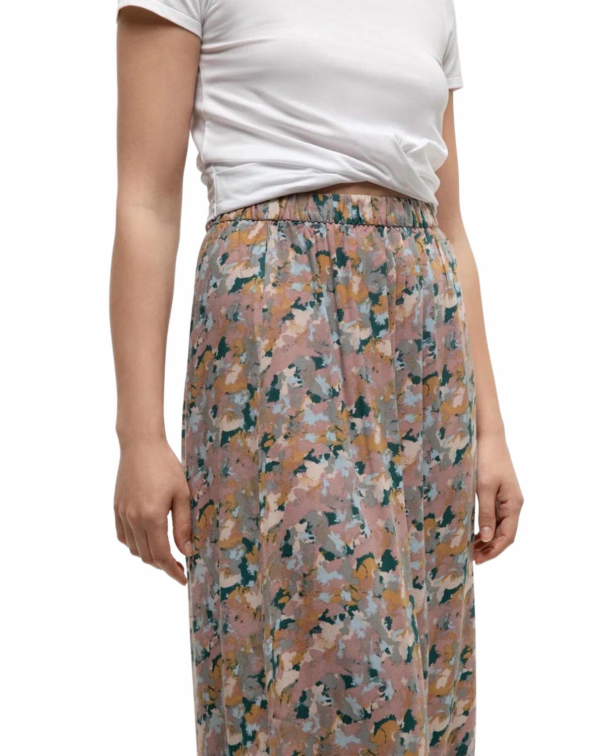 Midi skirt with abstract floral print in muted pastel tones, worn with white t-shirt