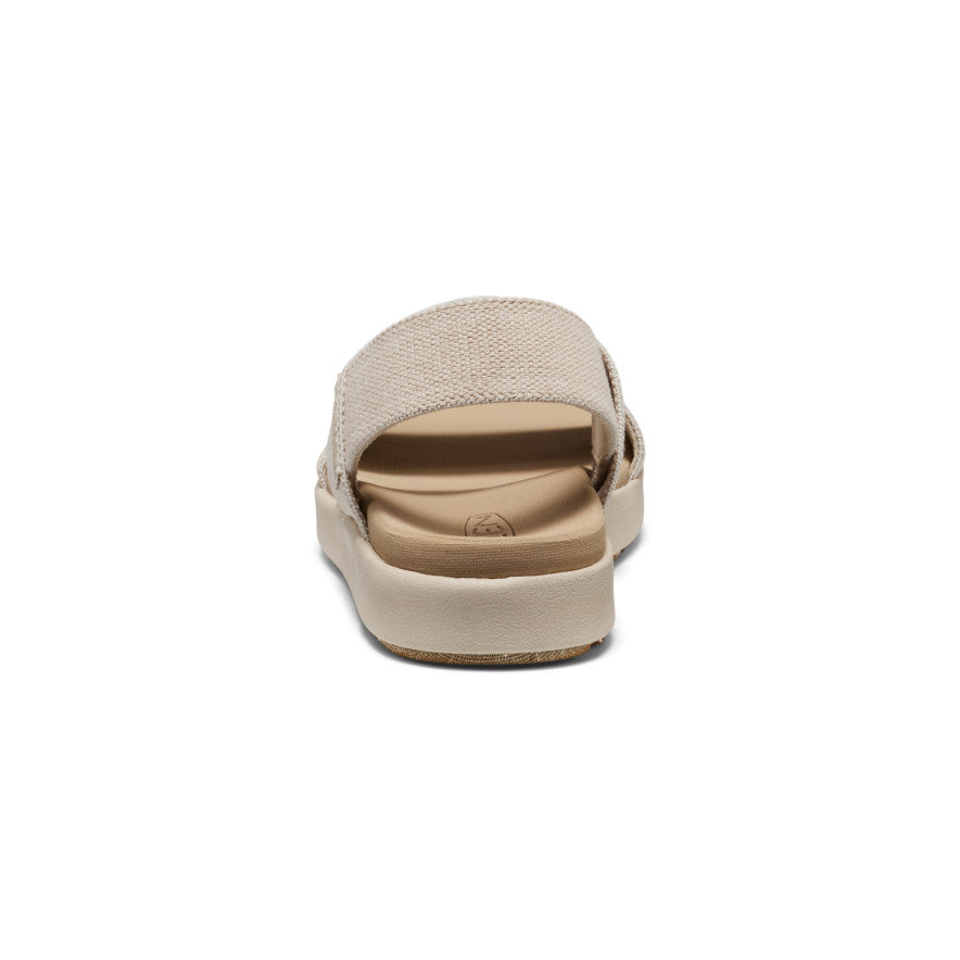 Beige canvas backstrap sandal with adjustable heel strap, rear view showing sole and footbed