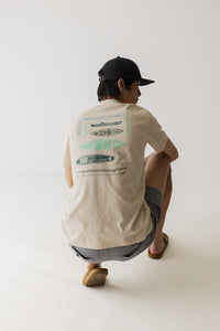 Men's short sleeve shirt with kayak illustrations on back, shown from behind on crouching model