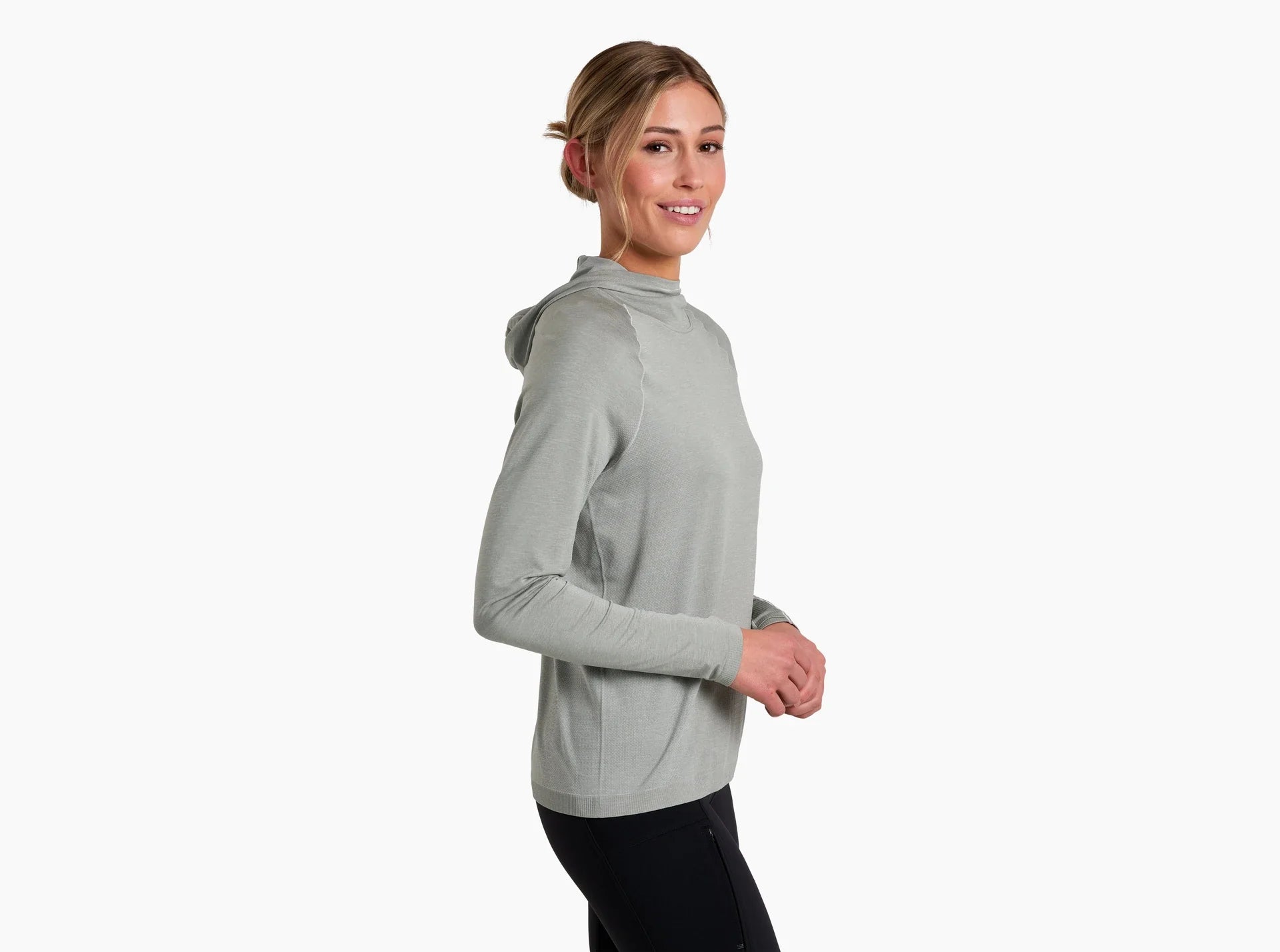 Light green hooded pullover with long sleeves shown from side angle on woman