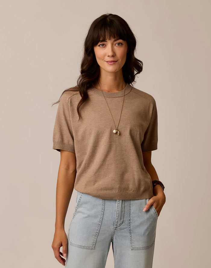 Women's short-sleeve knit sweater tee in warm taupe, front view, paired with light wash jeans
