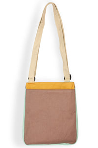 Cross-body bag with adjustable strap featuring colorful blocked pattern in pastel tones