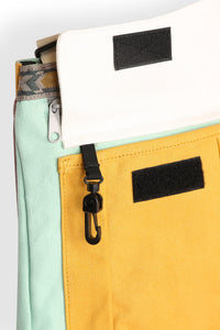 Multi-colored crossbody bag with zippered compartments and adjustable strap, detail view