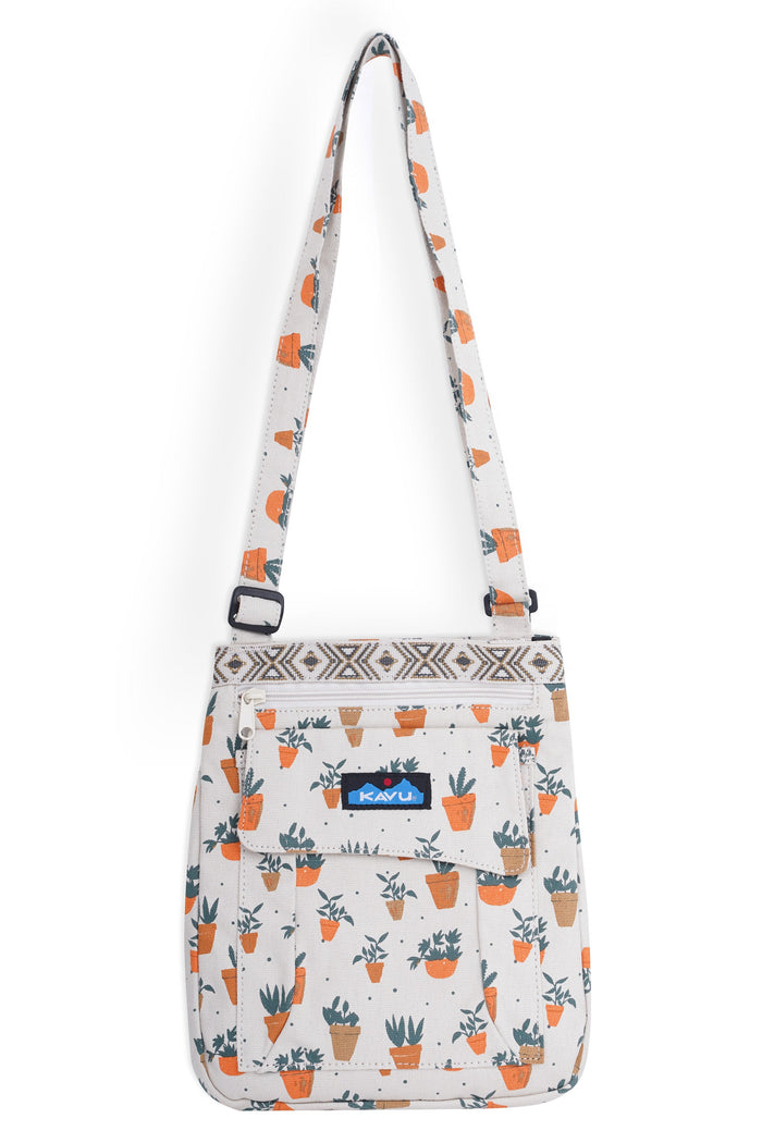 Small crossbody bag with plant pot pattern and adjustable strap on white background